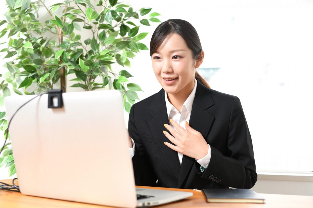 A woman in a suit undergoing a web interview